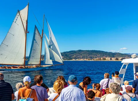 Catamaran following the Cannes Royal Regatta race fleet